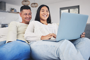 Image showing Smile, laptop and couple networking on a sofa to relax in the living room of their modern house. Happy, love and young man and woman watching a funny video on the internet with a computer at home.