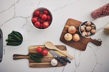 Image showing Cooking, food and top view of vegetables in kitchen on wood board for cutting, meal prep and nutrition. Healthy diet, ingredients and above of tomato, onions and mushrooms for dinner, lunch or supper