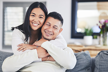 Image showing Happy, portrait and woman hugging her husband while relaxing on a sofa in the living room. Smile, love and face of an Mexican female person with a man in the lounge of their modern house together.