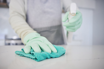 Image showing Person, hands and cleaning table with spray bottle in kitchen hygiene, germ or bacteria removal at home. Closeup of maid or cleaner wiping counter with cloth and detergent in healthy disinfection