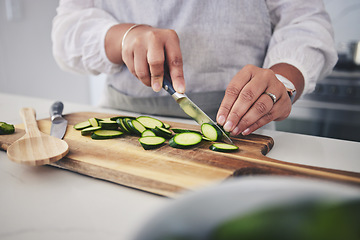 Image showing Cut, cucumber and hands cooking vegetable in a kitchen on a board or table in a home for hygiene as a chef. Salad, food and person prepare produce for a supper, lunch or dinner for diet meal