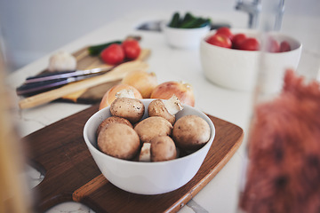 Image showing Cooking, food and vegetables on kitchen counter for meal prep, cutting and nutrition on wooden board. Healthy diet, ingredients and closeup of mushrooms in bowl for vegan dinner, lunch and supper