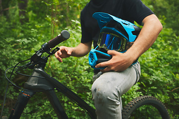 Image showing Mountain bike, man and helmet, forest and sports with adventure and fitness in nature outdoor. Cycling, biker and travel with athlete, exercise training and ready to ride, bicycle and challenge