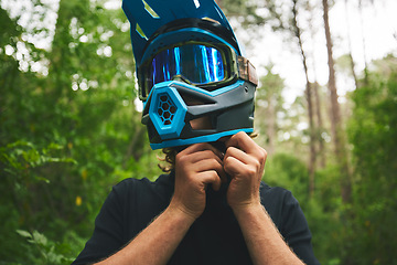 Image showing Helmet, hands and person in forest, cycling outdoor and safety with adventure and fitness. Protection, gear and travel, athlete and extreme sports with exercise, training and challenge with biking