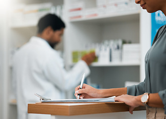 Image showing Woman at pharmacy, clipboard and medical insurance information at counter for script for prescription medicine. Paperwork, writing and patient at pharmacist with application for pharmaceutical drugs.