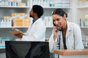 Image showing Pharmacist, woman and phone call for customer support, medicine stock and inventory communication or retail service. Medical worker or doctor on telephone and computer for pharmacy or healthcare FAQ