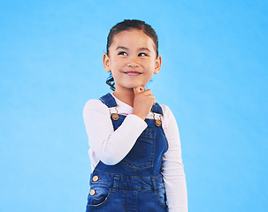 Image showing Thinking, child and girl with ideas, solution and problem solving on a blue studio background. Mockup space, kid and model with planning, emoji and inspiration with decision, choice and opportunity