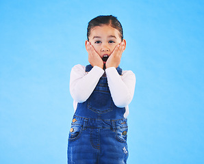 Image showing Portrait, wow and girl excited, surprise and announcement on a blue studio background. Female kid, shock or model with hands on face, emoji and prize with a winner, giveaway or news with mockup space