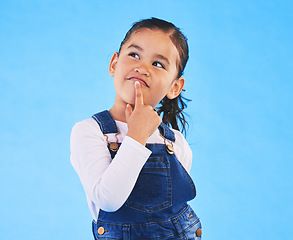 Image showing Thinking, kid and girl with ideas, decision and problem solving on a blue studio background. Mockup space, child and model with doubt, planning and inspiration with questions, remember or opportunity