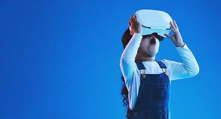 Image showing Wow, virtual reality and futuristic with girl, glasses or online gaming on blue studio background. Internet, surprise or child with vr headset, mockup space or digital transformation with video games