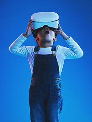 Image showing Wow, girl and kid with virtual reality glasses, futuristic and metaverse on a blue studio background. Child, person and model with vr headset, future and online gaming with expression and technology