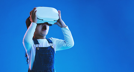 Image showing Future, virtual reality or girl with glasses, metaverse or augmented reality on a blue studio background. Futuristic, kid or child development with vr headset, online gaming or digital transformation