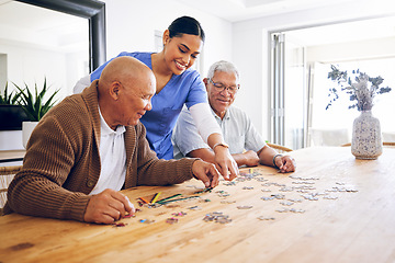 Image showing Puzzle, caregiver and senior men playing a game as entertainment or bonding together in a retirement home. Happy, fun and elderly people enjoy mental rehabilitation and development with nurse