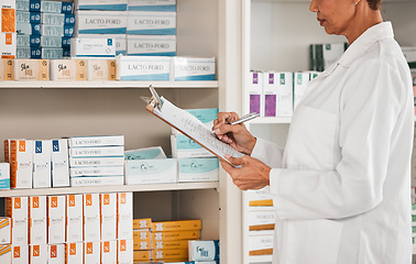 Image showing Woman, pharmacist and writing on clipboard for inventory inspection on pills, tablets or medication on shelf at pharmacy. Female person or medical worker checking stock or pharmaceutical at drugstore