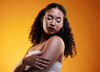 Image showing Beauty, hair and makeup with face of woman in studio for texture, fashion and cosmetics. Self care, salon and hairstyle with model on orange background for skincare, spa treatment and glow mockup