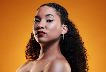 Image showing Beauty, curly hair and makeup with portrait of woman in studio for texture, health and cosmetics. Self care, salon and hairstyle with model on orange background for skincare, spa treatment and mockup