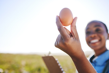 Image showing Happy woman on farm with egg in hand, inspection on field, quality assurance and sustainable small business farming in Africa. Poultry farmer with checklist and person in countryside with grass.