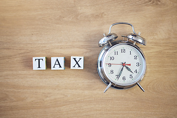 Image showing Taxes, clock and finance with building blocks on table from above for planning, future and investment. Budget, payment and accounting with message and alarm for time, income and economy mockup