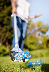 Image showing Park, pollution and closeup for cleaning, plastic bottle and and tools for climate change in nature. Person, garbage or trash on grass with help for environment, forest or earth with sustainability