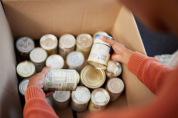 Image showing Donation, food in cans in box and hands of man checking stock, decision and volunteer with ngo help. Support with charity, choice and refugee at grocery distribution for sustainable community service