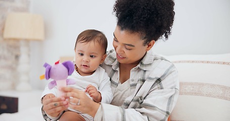 Image showing Mother, baby or child with a toy at home for development and growth. Cute toddler or infant kid playing with a woman or parent for love, care and security while learning mobility in a family bedroom