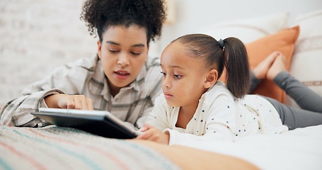 Image showing Tablet, elearning and mother with girl in bedroom, education and bonding in home. Tech, happy and African mom with child on bed for streaming movie, video or film on social media to relax together.