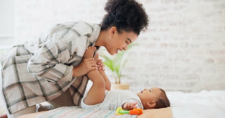 Image showing Mother, baby or child with a toy for development, learning and growth in family home. Cute toddler or infant kid with woman or parent for love, care and security while playing for mobility in bedroom