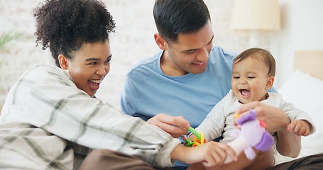 Image showing Family, couple and quality time with baby, mom and dad playing with toys for fun, laughing together in home, bedroom or nursery. Newborn, infant and happiness in motherhood, family or child smile