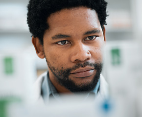 Image showing Black man, face and pharmacist, drugs and health with medicine, prescription and organize stock in pharmacy. Pills, healthcare and African medical employee, hospital dispensary and pharmaceutical