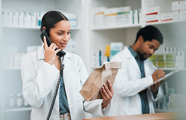 Image showing Pharmacist, telephone and medicine package for customer service, healthcare communication and inventory support. Medical worker, people or doctor on phone call with pharmacy product or paper bag