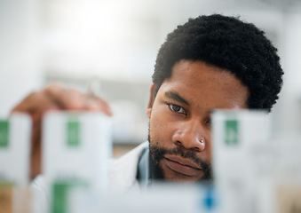 Image showing Black man, pharmacist, drugs and health with medicine, prescription and organize stock in pharmacy. Pills, inventory with healthcare and African medical worker, hospital dispensary and pharmaceutical