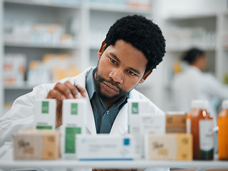 Image showing Black man, pharmacist and check stock, pills and health, prescription medicine and supplements in pharmacy. Organize inventory, healthcare and medical, hospital dispensary and pharmaceutical drugs