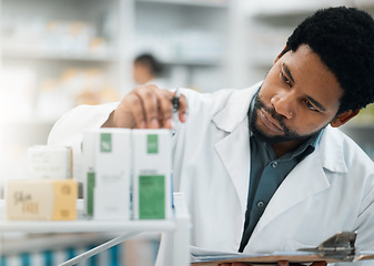 Image showing Black man, pharmacist and check stock, drugs and health, prescription medicine and supplements in pharmacy. Organize inventory, healthcare and medical, hospital dispensary and pharmaceutical pills