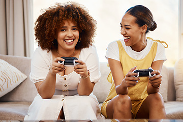 Image showing Portrait of women on sofa playing video game, excited fun and relax in home living room together on internet. Online gaming, esports and happy gamer girl friends on couch on virtual app in apartment.