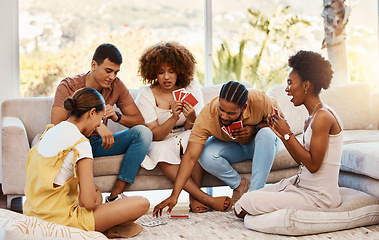 Image showing Game, relax or friends playing cards, poker or black jack at home for gambling together in a holiday party. Diversity, men or group of happy women laughing in living room in a fun match competition