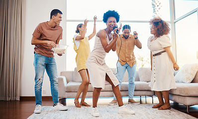 Image showing Singing, music and friends doing karaoke in the living room with microphone to playlist or radio. Happy, diversity and young people dancing, bonding and having fun together for entertainment at home.