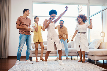 Image showing Sing, energy and friends dancing in the living room with a microphone to music, playlist or radio. Happy, diversity and young people moving, bonding and having fun together with karaoke at home.