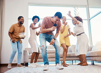 Image showing Singing, party and friends dancing in the living room with a microphone to music, playlist or radio. Happy, diversity and young people moving, bonding and having fun together with karaoke at home.