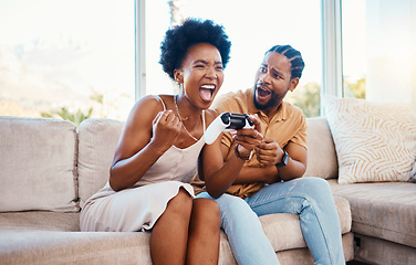Image showing Gaming, winner and a black couple on a sofa in the living room of their home together for bonding. Love, fun or competition with a gamer man and woman playing online using a console in their house