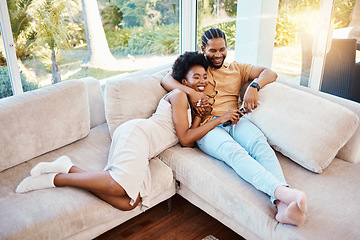 Image showing Happy, above and a black couple on the sofa, watching tv and talking in a house. Smile, love and an African man and woman with care, speaking and conversation on the living room couch for a movie