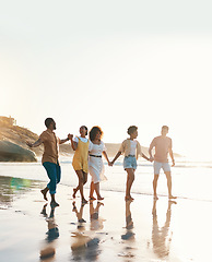 Image showing Summer, holding hands and travel with friends at beach for freedom, support and sunset. Wellness, energy and happy with group of people walking by the sea for peace, adventure and vacation mockup