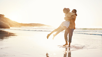 Image showing Beach, sunset and happy couple hug, celebrate summer and enjoy romantic time together, bonding and love on travel holiday. Sun flare, sea and excited people embrace on tropical marriage honeymoon