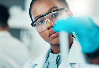 Image showing Science, study and black woman with test tube in laboratory, medical engineer and results. Biotechnology, pharmaceutical and research, scientist or lab technician checking vaccine solution in glass.