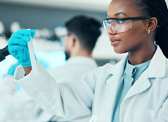 Image showing Science, research and black woman with test tube in laboratory, results and medical engineer. Biotechnology, pharmaceutical study and vaccine, scientist or lab technician checking solution in glass.