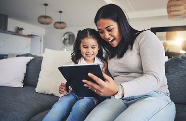 Image showing Tablet, surprise and a mother on the sofa with her daughter in the living room of their home together. Wow, family or children with a mother and girl looking at social media or a good news email