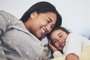 Image showing Laugh, mother and daughter in bed at home with love, care and happiness in morning. A young woman and girl child together in a bedroom for fun time, playing and security or relax in a family house