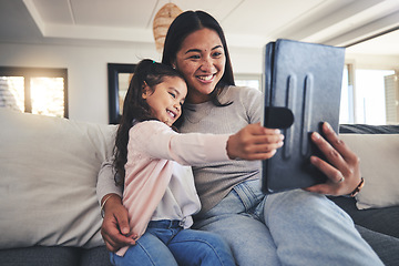 Image showing Tablet, selfie and a mother on the sofa with her daughter in the living room of their home together. Photograph, family or children with a mother and girl taking a profile picture for social media