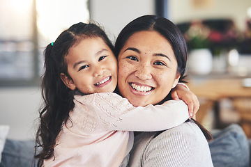 Image showing Smile, mother and daughter hug for a portrait at home with love, care and happiness. A young woman and girl child together on a lounge sofa for fun time, playing and security or relax in family house