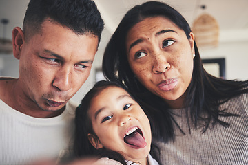 Image showing Selfie, silly and portrait of girl with her parents bonding in the living room of their home. Goofy, happy and child taking a picture with her mother and father with funny faces at their family house