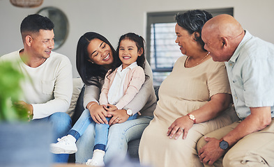 Image showing Happy, care and a big family on the sofa with a child during a visit for love, bonding and playing. Smile, laughing and a girl kid with parents and grandparents on the home couch to relax and talk